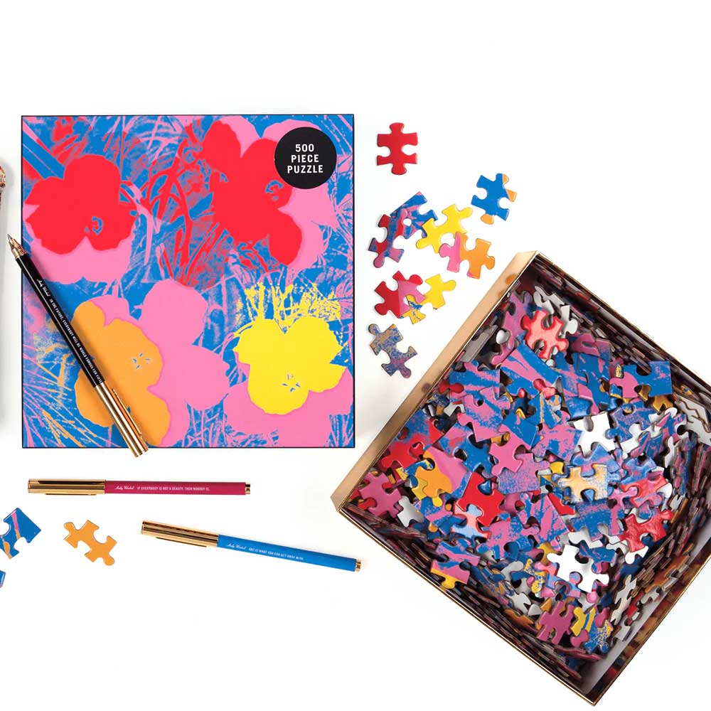 The Guggenheim Museum Andy Warhol Flowers 500 Piece Jigsaw Puzzle, box and pencils scattered on a white surface.