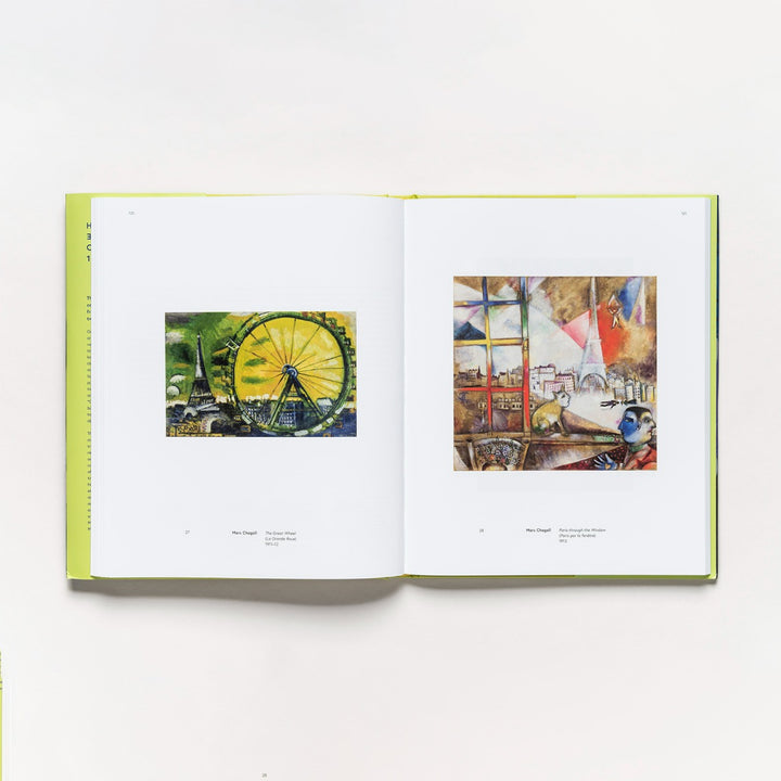 An open copy of "Harmony and Dissonance: Orphism in Paris, 1910–1930" lies on a white surface, displaying a ferris wheel painting on the left page and an abstract Orphism-inspired cityscape on the right.