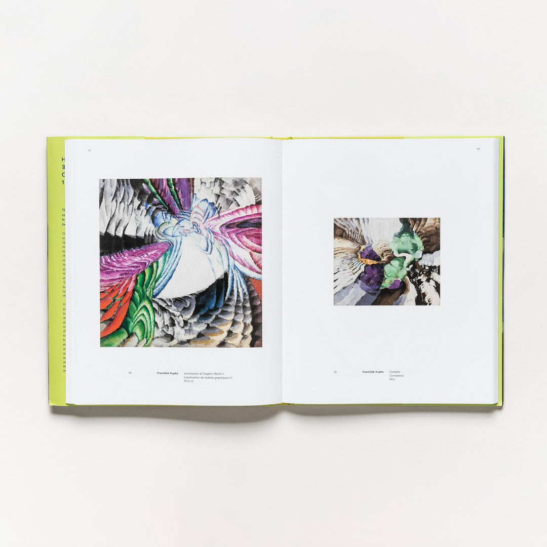 An open book, "Harmony and Dissonance: Orphism in Paris, 1910–1930," displays two vibrant abstract artworks with layered, swirling shapes—bold and colorful on the left page, with a smaller yet similar piece on the right.