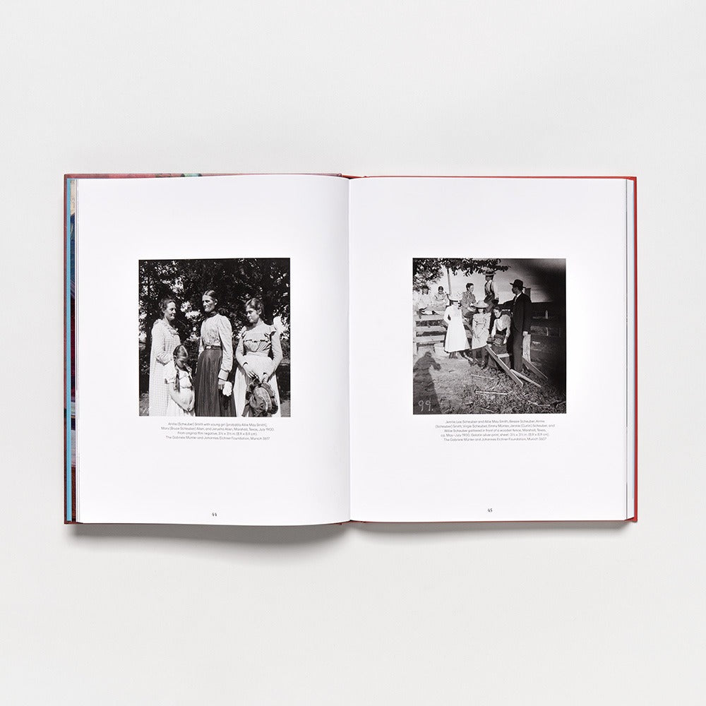 An open hardcover of "Gabriele Münter: Contours of a World" rests on a white surface, displaying two pages with black-and-white photos of people in historical attire outdoors—an elegant preview of timeless style for 2025.