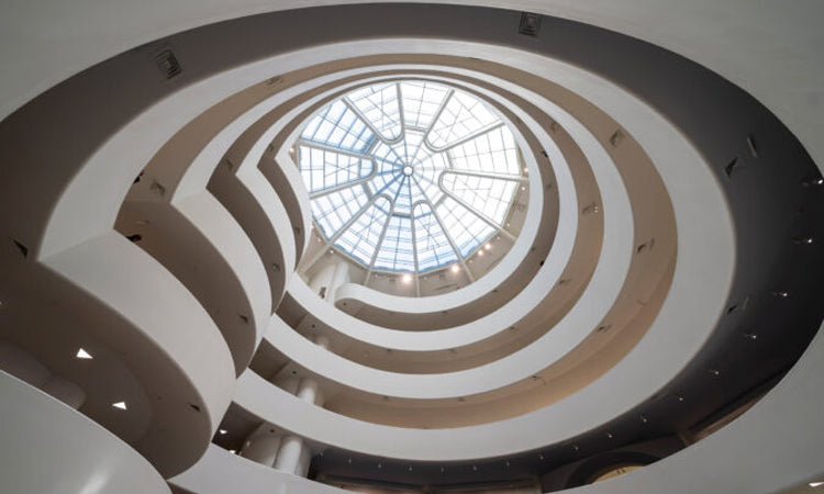 View looking up at the spiral ramp and glass dome ceiling of the Guggenheim Museum in New York City.