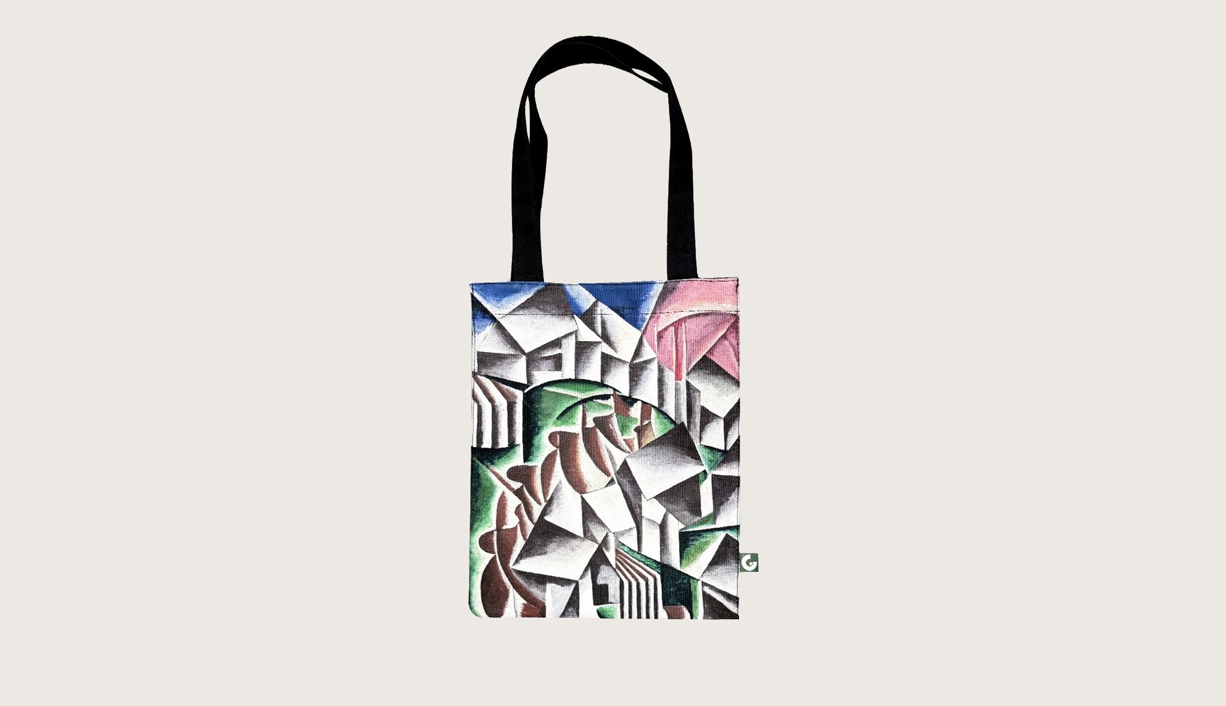 Tote bag with abstract geometric design in green, brown, black, blue, and pink, featuring black handles.