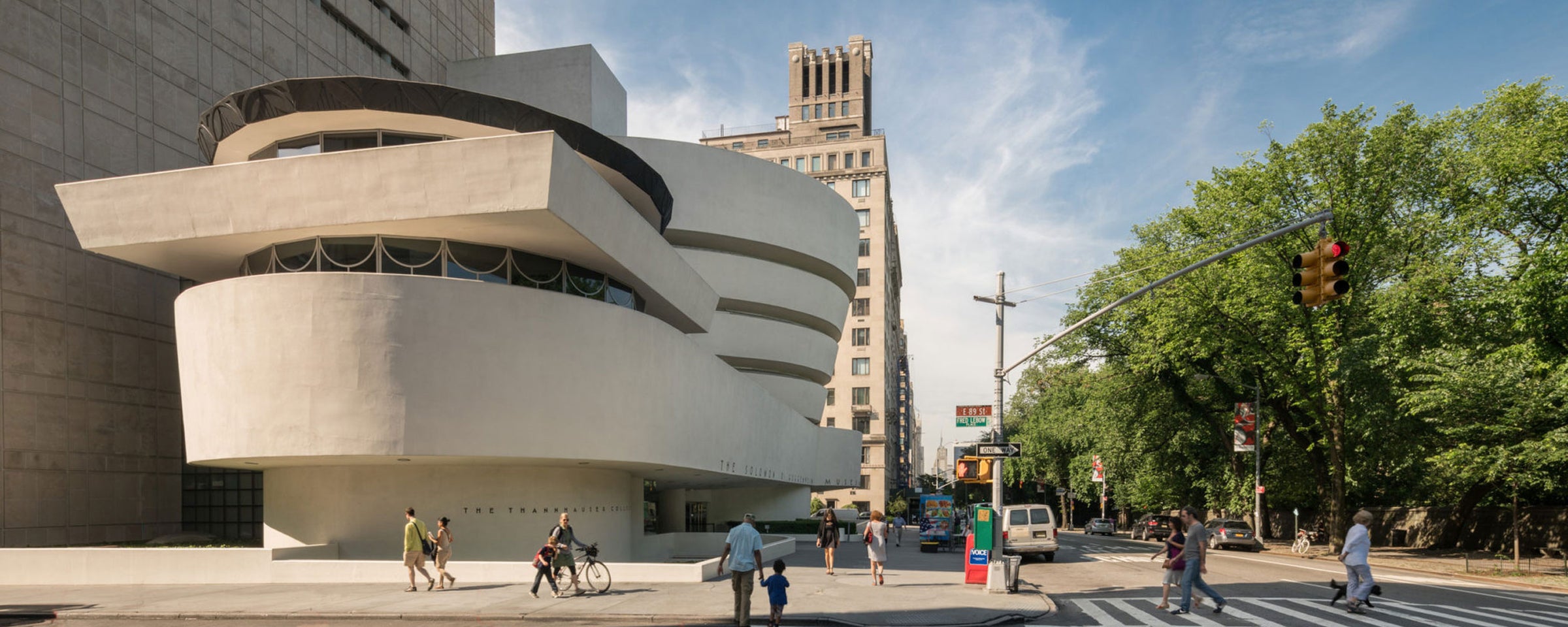 Spiral building with people walking around, including a Guggenheim Museum-like structure.