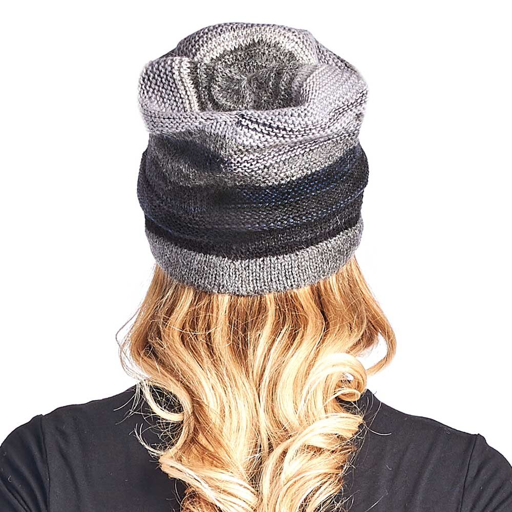 A person with long, wavy blonde hair wears the Colorado Alpaca Beanie in Charcoal, photographed from behind against a white background.
