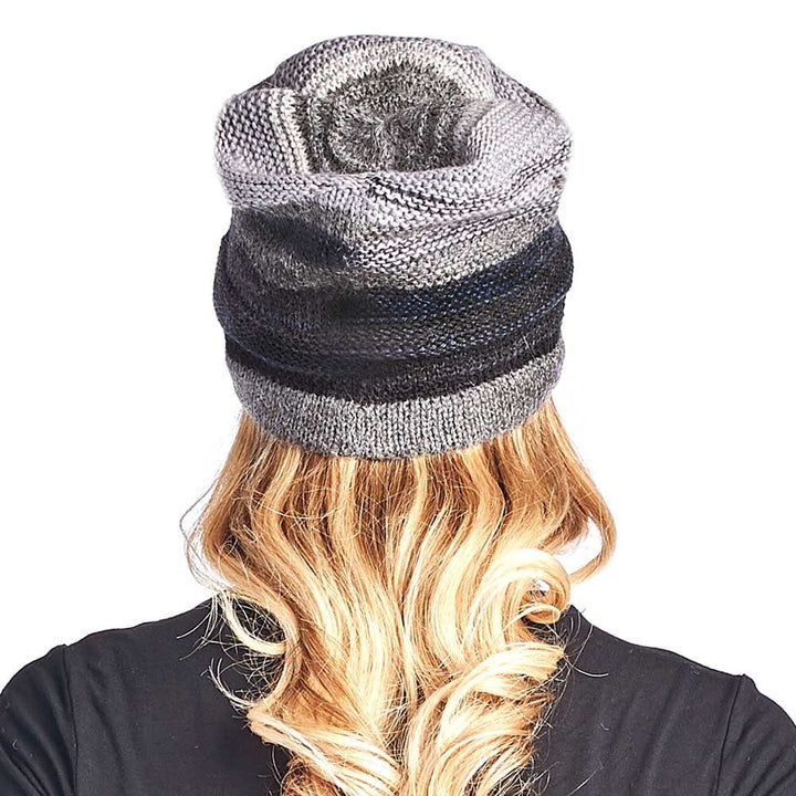 A person with long, wavy blonde hair wears the Colorado Alpaca Beanie in Charcoal, photographed from behind against a white background.