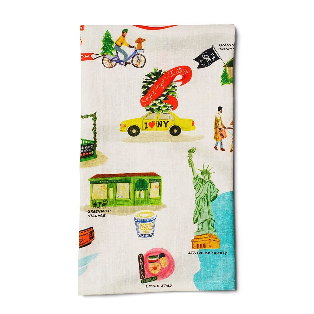 The Holiday in New York Tea Towel features vibrant prints of NYC icons—like a yellow taxi with a Christmas tree, the Statue of Liberty, and Greenwich Village—on white, phthalate-free fabric for a festive and safer touch.