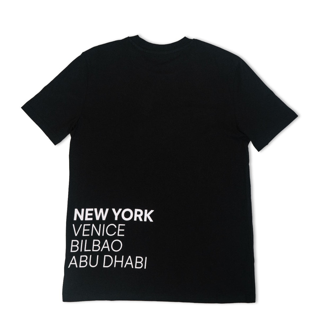 The Guggenheim Constellation T-Shirt, New York Black, features city names in bold white text on the lower left back. This art institution apparel is crafted from soft organic cotton for a modern look.