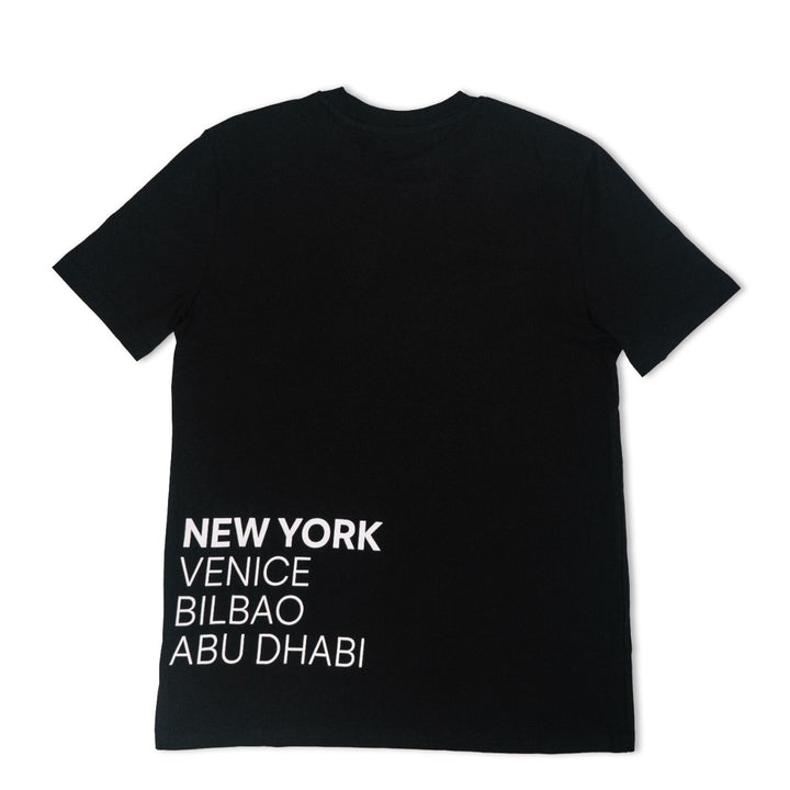 The Guggenheim Constellation T-Shirt, New York Black, features city names in bold white text on the lower left back. This art institution apparel is crafted from soft organic cotton for a modern look.
