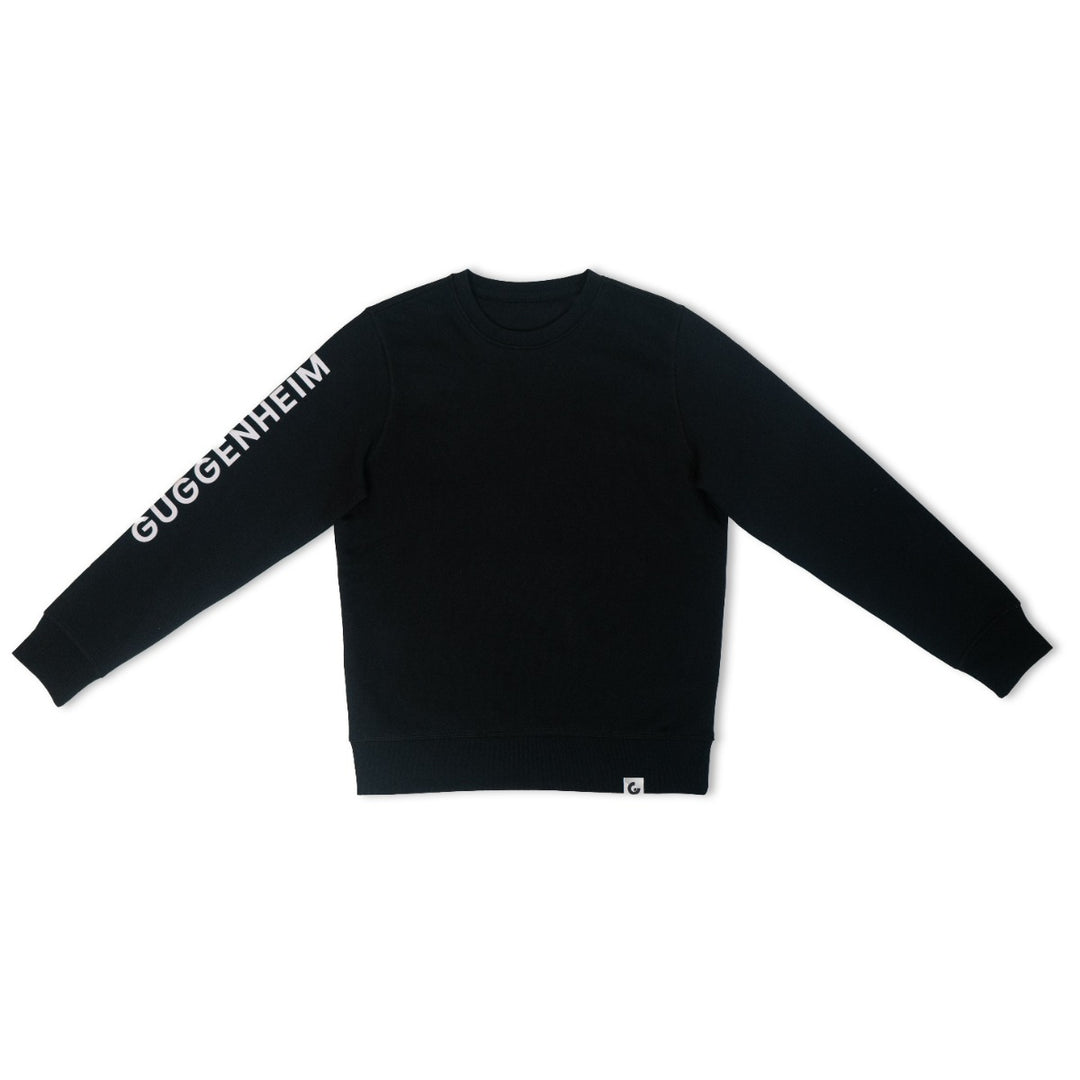 The Guggenheim Constellation Crewneck Sweatshirt, New York Black, is an organic cotton sweatshirt featuring GUGGENHEIM in white lettering along the left sleeve—ideal for fans of art institution apparel.