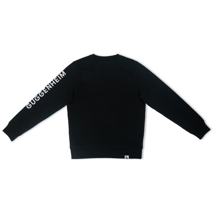 The Guggenheim Constellation Crewneck Sweatshirt, New York Black, is an organic cotton sweatshirt featuring GUGGENHEIM in white lettering along the left sleeve—ideal for fans of art institution apparel.