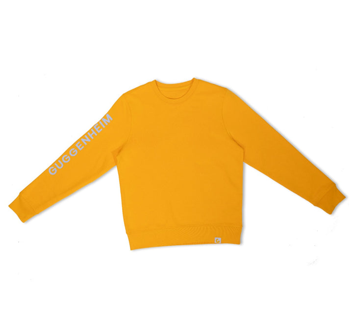 The Guggenheim Constellation Crewneck Sweatshirt in New York Yellow is an organic cotton sweatshirt with GUGGENHEIM in white on the right sleeve, featuring a crew neck, ribbed cuffs and hem for a classic art institution-inspired look.