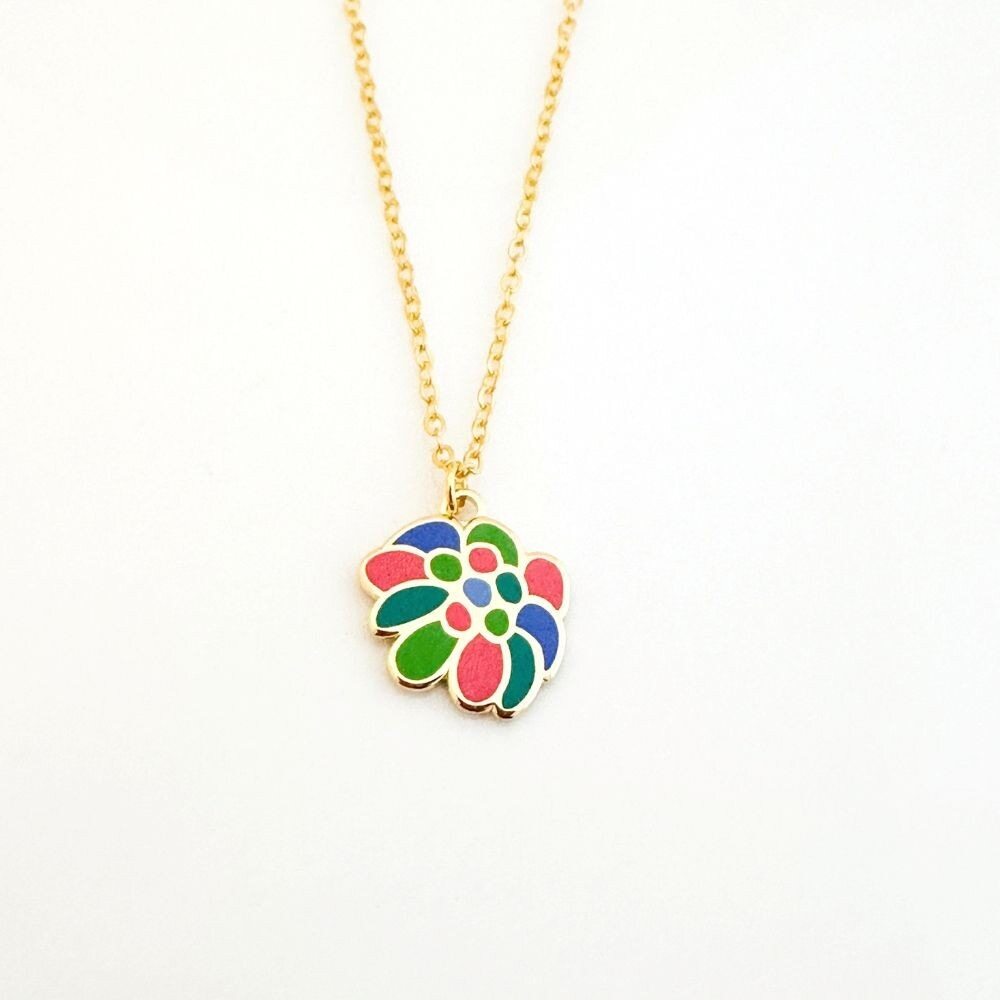 The Gabriele Münter Red Flower Pendant Necklace features a 0.6 inch gold chain with a colorful flower-shaped pendant—blue, green, pink, and red petals on white—and is secured with a lobster clasp for easy wear.