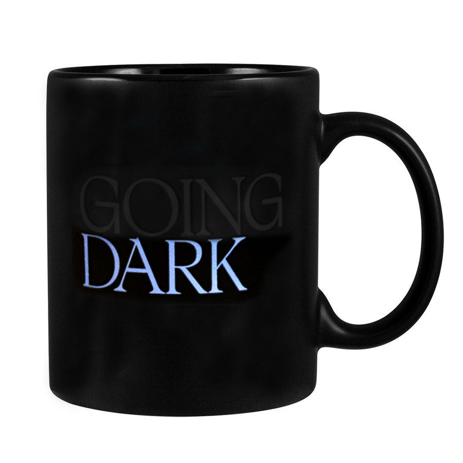 The Going Dark Color Changing Mug is a black stoneware mug that reveals “GOING DARK”—with “GOING” in faint gray and “DARK” in bold white—perfect for fans of contemporary artists and modern design.