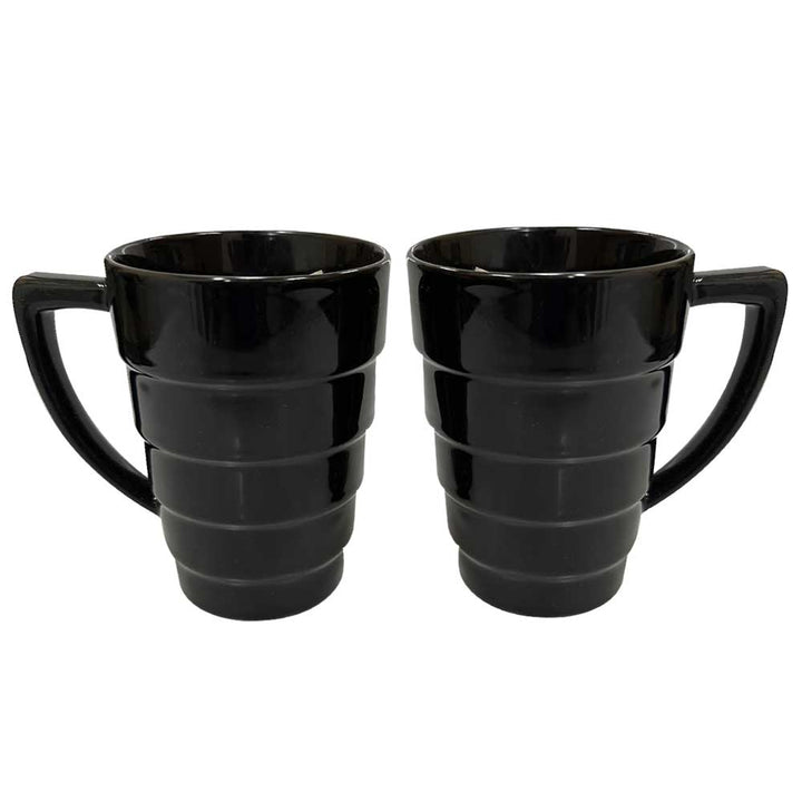 Two 1959 Modern Black 12oz Mugs with large handles and a tiered, ridged design sit side by side on a white background—a stylish mug set ideal for any contemporary kitchen.