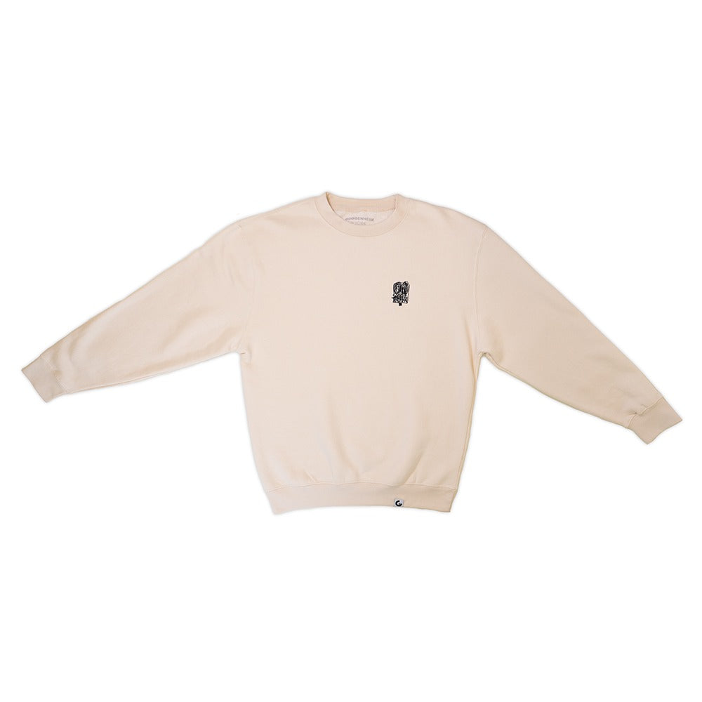 The Guggenheim Rashid Johnson Anxious Man Embroidered Sweatshirt is a cream crewneck with a small black graphic on the left chest and a tiny logo near the hem, inspired by contemporary art, shown laid flat on a white background.