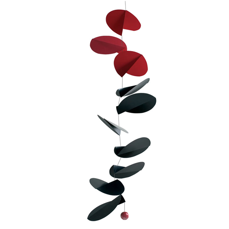 The Turning Leaves Mobile by Flensted features alternating flat, oval shapes in red and black suspended vertically on thin wire, finished with a small red sphere at the bottom.
