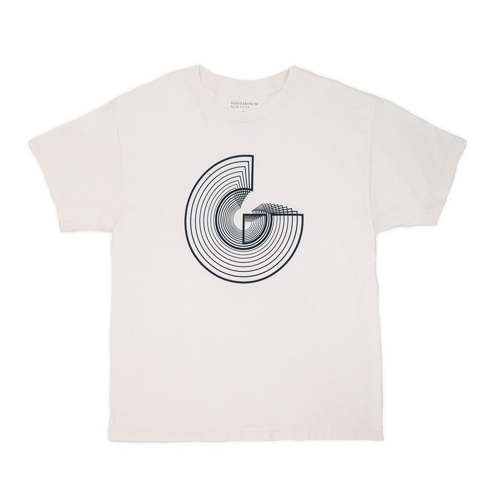 The Guggenheim Icon T-Shirt, Natural, is a white unisex cotton shirt showcasing a bold black abstract geometric design on the chest, inspired by art and architecture, with a stylized "G" reminiscent of the iconic Guggenheim.