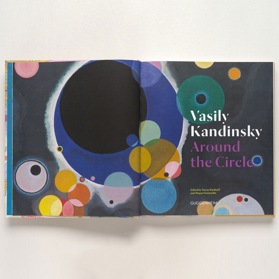 Open book featuring abstract art by Vasily Kandinsky with colorful circles on dark background. Cover text: Vasily Kandinsky: Around the Circle. Product name: Vasily Kandinsky: Around the Circle.