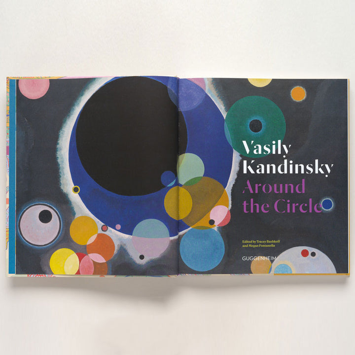 Open book featuring abstract art by Vasily Kandinsky with colorful circles on dark background. Cover text: Vasily Kandinsky: Around the Circle. Product name: Vasily Kandinsky: Around the Circle.