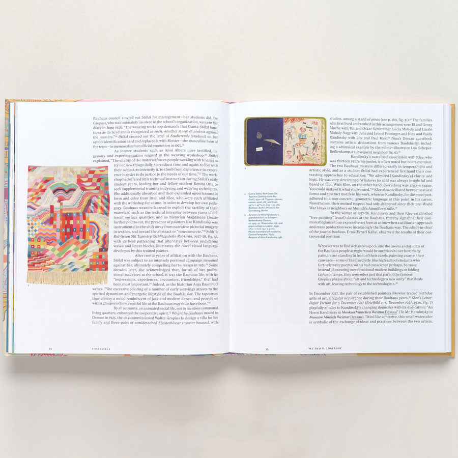 An open book, "Vasily Kandinsky: Around the Circle," displays colorful textile art inspired by European modernism on the left and a smaller textile image with text on the right, all on white paper against a neutral background.