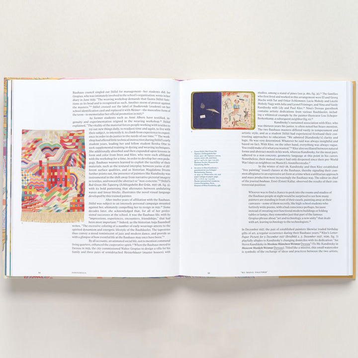 An open book, "Vasily Kandinsky: Around the Circle," displays colorful textile art inspired by European modernism on the left and a smaller textile image with text on the right, all on white paper against a neutral background.