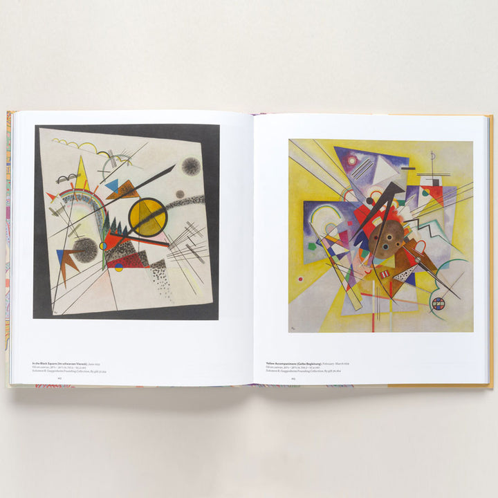 An open copy of "Vasily Kandinsky: Around the Circle" displays abstract European modernist art with colorful circles and triangles in the Bauhaus style, shown on cream pages against a light background.