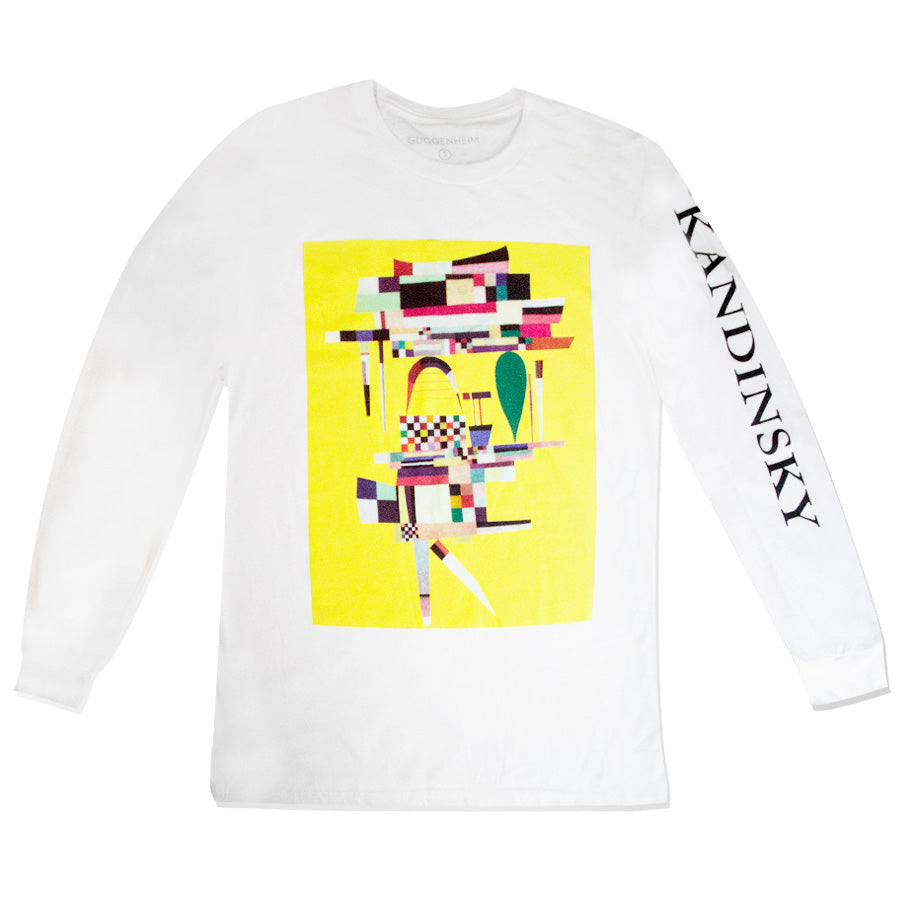 The Kandinsky Long-Sleeve Shirt, Yellow Painting, is a white shirt with a vibrant abstract geometric design on a yellow background and "KANDINSKY" in black capitals down one sleeve, celebrating the artist's iconic Guggenheim Museum work.