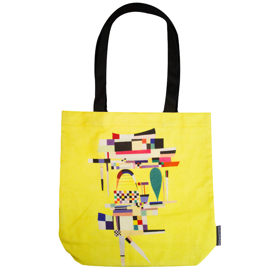 The Kandinsky Tote Bag, Yellow Painting, is a yellow tote bag with black handles featuring an abstract geometric design inspired by Kandinsky—perfect for art lovers and reminiscent of pieces at the Guggenheim Museum.