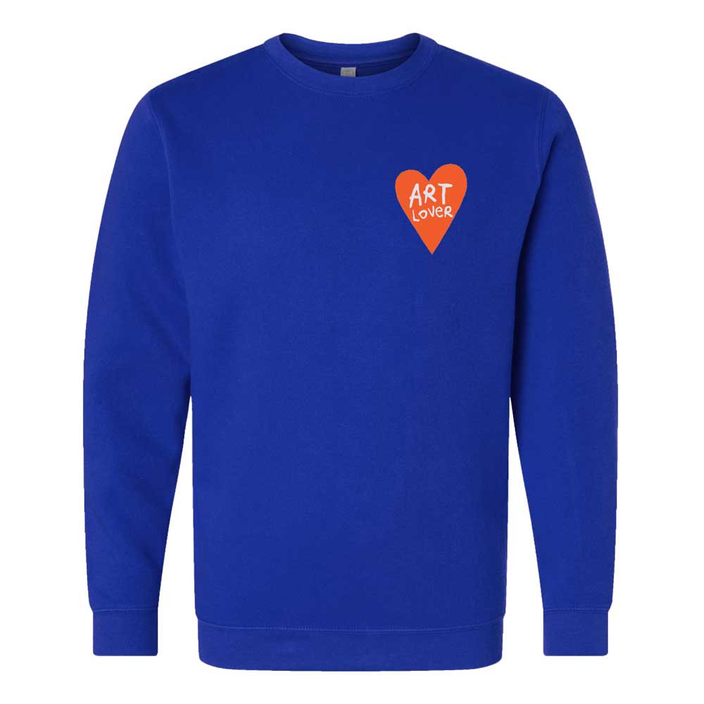 The Art Lover Embroidered Crewneck Sweatshirt features royal blue fabric with a small red heart on the left chest and “ART LOVER” in white, handwritten-style text—wearable art inspired by Humberto Cruz.