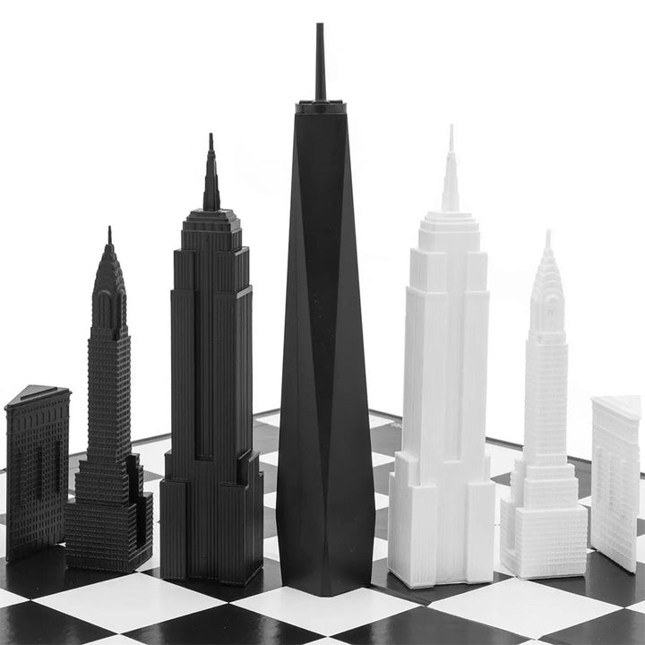 The New York City Edition - Chess Set features six acrylic pieces—three black and three white—inspired by iconic skyscrapers, forming a distinctive, abstract skyline on your chessboard.