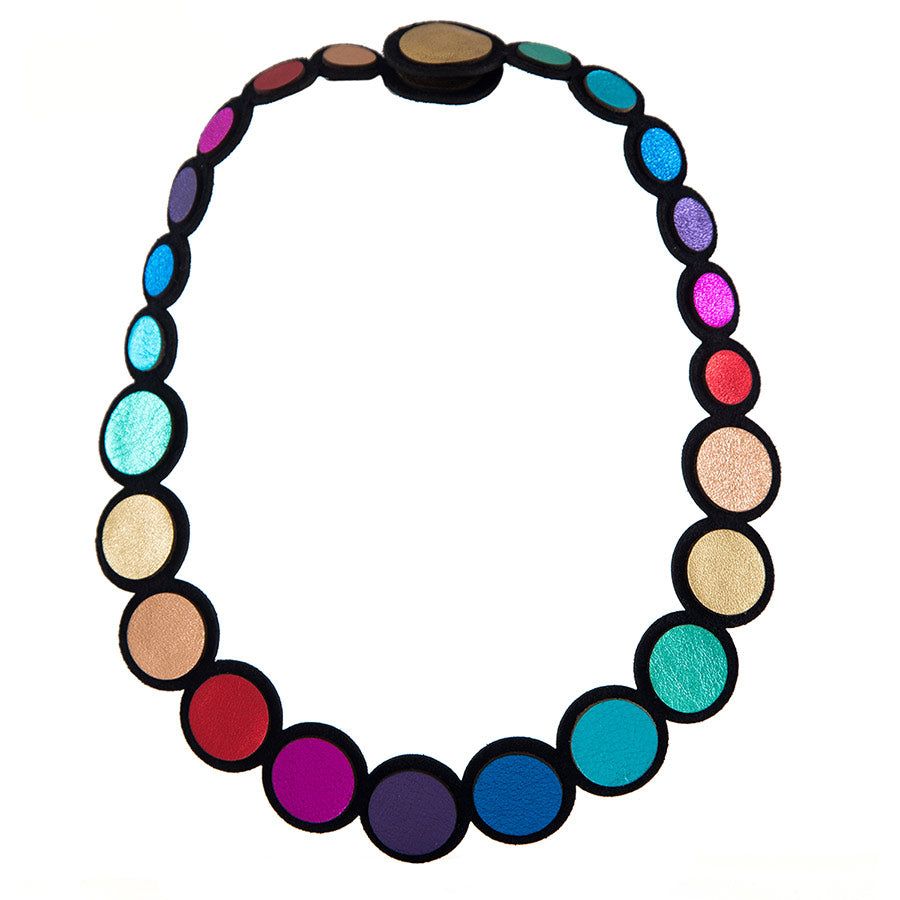 The Rainbow Circles Necklace by Iskin Sisters features lightweight, connected colorful circular discs—blue, purple, red, gold, and pink—outlined in black and shown against a white background.