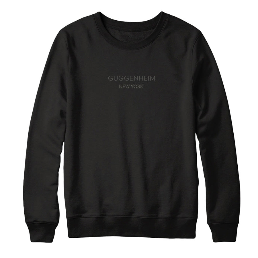 The Guggenheim Going Dark Crewneck Sweatshirt is a black crewneck with a logo, inspired by contemporary artists.