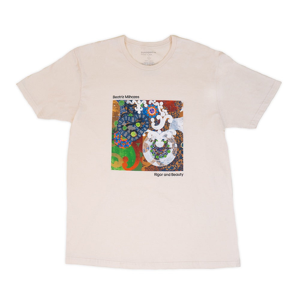 The Guggenheim Beatriz Milhazes "Rigor and Beauty" T-Shirt is cream-colored with a vibrant abstract artwork in the center, plus “Beatriz Milhazes” above and “Rigor and Beauty” below the art.